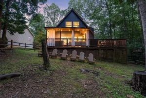 a large house with a porch and chairs in the yard at Adventures on Alleghany in McGaheysville