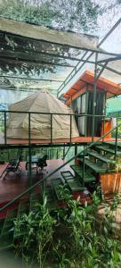 a house with a tent and a table and chairs at Glamping Butterflay Garden in Concepción