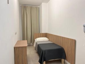 A bed or beds in a room at Hotel Brivio
