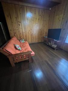 a room with a bed and a flat screen tv at Cabaña del centro in Puerto Iguazú +3 photos
