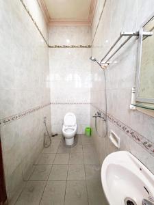 a bathroom with a toilet and a sink at Harmadha Villa in Sarangan