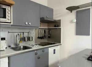 a kitchen with a sink and a counter top at Super Studio à proximité de Genève in Saint-Julien-en-Genevois