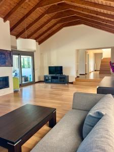 a living room with a couch and a table at V Mira Luxury Villa in Tragaki