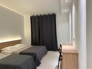 A bed or beds in a room at Hotel Brivio