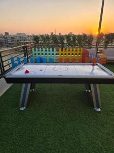a ping pong table with colorful chairs on a balcony at West Somid Luxury Serviced Apartments in 6th Of October