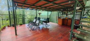 a screened in porch with a table and chairs on a deck at Glamping Butterflay Garden in Concepción +12 photos