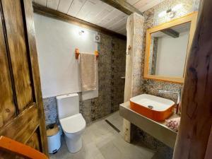 a bathroom with a toilet and a sink at The artist House Matala in Pitsidia +27 photos