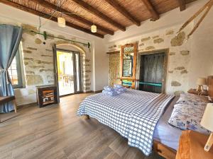 a bedroom with a bed and a fireplace at The artist House Matala in Pitsidia