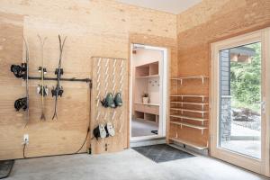 a room with a pivot door and a room with shoes at Camozzi Chalet by Revelstoke Vacations in Revelstoke +45 photos