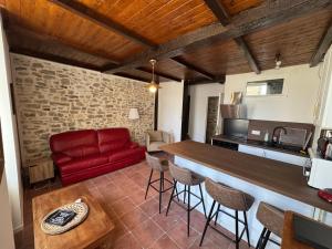 a kitchen and living room with a red couch at Le cottage des remparts Le triplex in Boulogne-sur-Mer