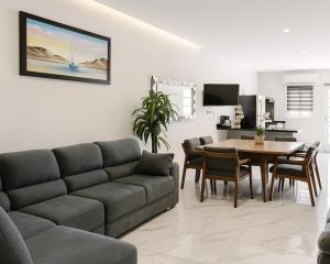a living room with a couch and a table at Sunset Suites Mazatlán at Lomas de Mazatlán in Mazatlán