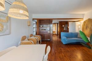 a living room with a blue couch and chairs at Serenity Troia in Troia
