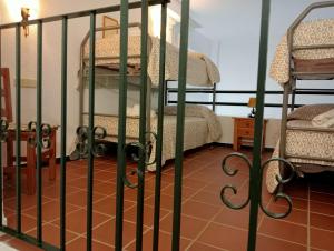 a room with a gate with a bunk bed at CANALIEGA PUENTE del REY in El Rocío