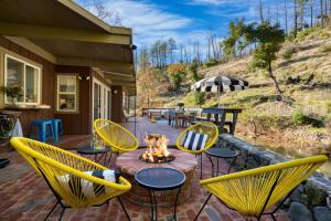 a patio with yellow chairs and a fire pit at Sonoma Creek Haven in Kenwood