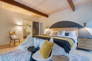 a large bedroom with a large bed and a chair at Sonoma Creek Haven in Kenwood