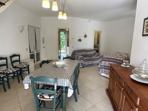 ein Wohnzimmer mit Tisch und Couch in der Unterkunft Villa Alessandra in Forte dei Marmi