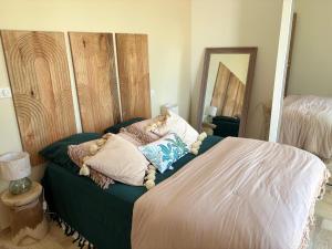 a bed with pillows on it in a room at Chjama di mare in Santa-Maria-di-Lota