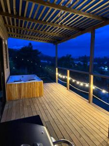 a large wooden deck with a hot tub on it at Alto Paraiso Glamping "A" in Carmen de Viboral +13 photos