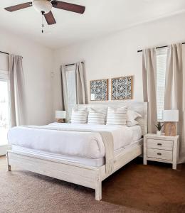 una camera bianca con letto bianco e ventilatore a soffitto di The Cliff Dweller - Peaceful Escape 50-mile Views a Page