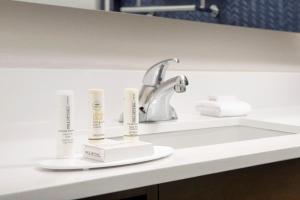 a sink in a bathroom with two products on it at Fairfield Inn & Suites by Marriott Alexandria West/Mark Center in Alexandria +16 photos