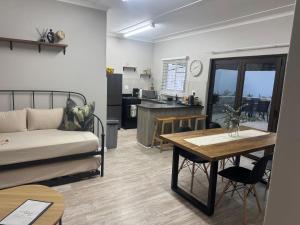 a living room with a couch and a table at The Olive Branch in Lutzville