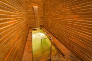 a small room with a metal door in a brick wall at Hotel Porto Santo & Spa in Porto Santo