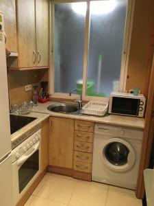 A kitchen or kitchenette at 44 Centro Apartaments & Suites