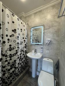 a bathroom with a sink and a toilet and a shower at Rose Art hotel in Astana