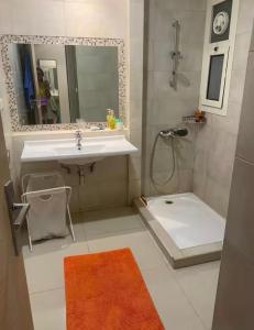 a bathroom with a sink and a shower with a mirror at Hacienda Bay-Spacious 3BR Chalet With Garden - North Coast in Mājid Abū Zayd