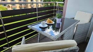a table with a plate of food on a balcony at Harz DeLuxe in Altenau in Altenau