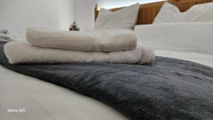 a pile of towels sitting on top of a bed at Harz DeLuxe in Altenau in Altenau