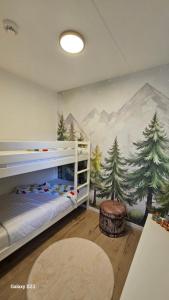 a bedroom with a mountain mural on the wall at Harz DeLuxe in Altenau in Altenau +16 photos
