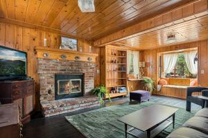 a living room with a fireplace and a couch at Pineland Getaway - Serene Escape in Green Valley Lake +18 photos