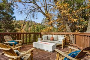 a patio with a couch and chairs on a deck at The Fancy Fox - Stunning 4 BR Retreat Close to Lake in Lake Arrowhead