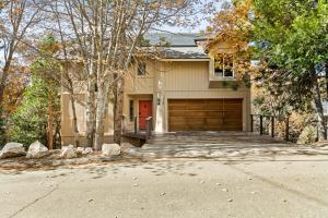 a house with a garage with a red door at The Fancy Fox - Stunning 4 BR Retreat Close to Lake in Lake Arrowhead