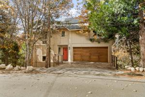 a house with a garage with a red door at The Fancy Fox - Stunning 4 BR Retreat Close to Lake in Lake Arrowhead