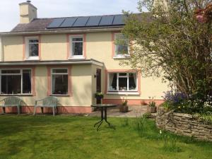 a house with a table and two chairs in the yard at Parc Farm B&B in Llanarth +16 photos