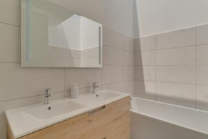 a white bathroom with a sink and a mirror at Cove Villa in Calheta in Bicas +21 photos