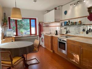 a large kitchen with a table and a table and a tableablish at Die wohnlichen Gästezimmer in Tornesch