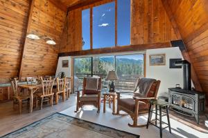 a dining room with a table and chairs and a fireplace at Yosemite Pines Cabin - Sleeps 6 in Big Bear Lake +33 photos