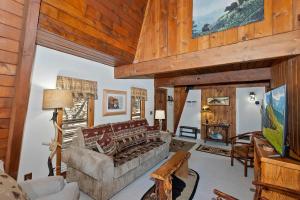 a living room with a couch and a table at Yosemite Pines Cabin - Sleeps 6 in Big Bear Lake