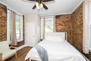 a bedroom with a bed and a brick wall at Ludlow Lodge with City Views in Ludlow