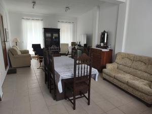 a living room with a couch and a table at Casa da Praça - Obidos Country Residence in Amoreira