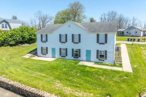 a white house on a yard with green grass at Arkstone Retreat 2 - Chic 2 Bedroom in Williamstown