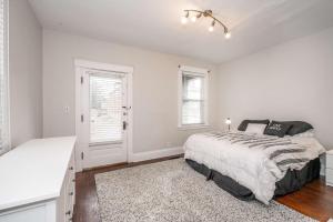 a bedroom with a bed and two windows at The Vista View Villa 1 Amazing Getaway for 2 in Cincinnati