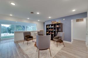 a waiting room with chairs and a book shelf at Beach House 2 on Lake LBJ - Sleeps 24 in Kingsland