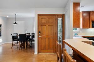 a kitchen and dining room with a wooden door at Pet-Friendly Marble Falls Home w Hot Tub in Marble Falls