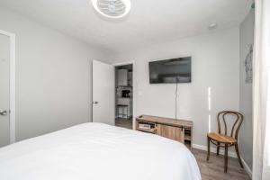 a bedroom with a bed and a desk and a tv at Arkstone Retreat 3 in Williamstown