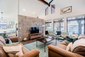 a living room with two couches and a tv at Lake LBJ Waterfront Family-Friendly Retreat in Granite Shoals