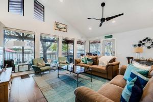 a living room with two couches and a table at Lake LBJ Waterfront Family-Friendly Retreat in Granite Shoals
